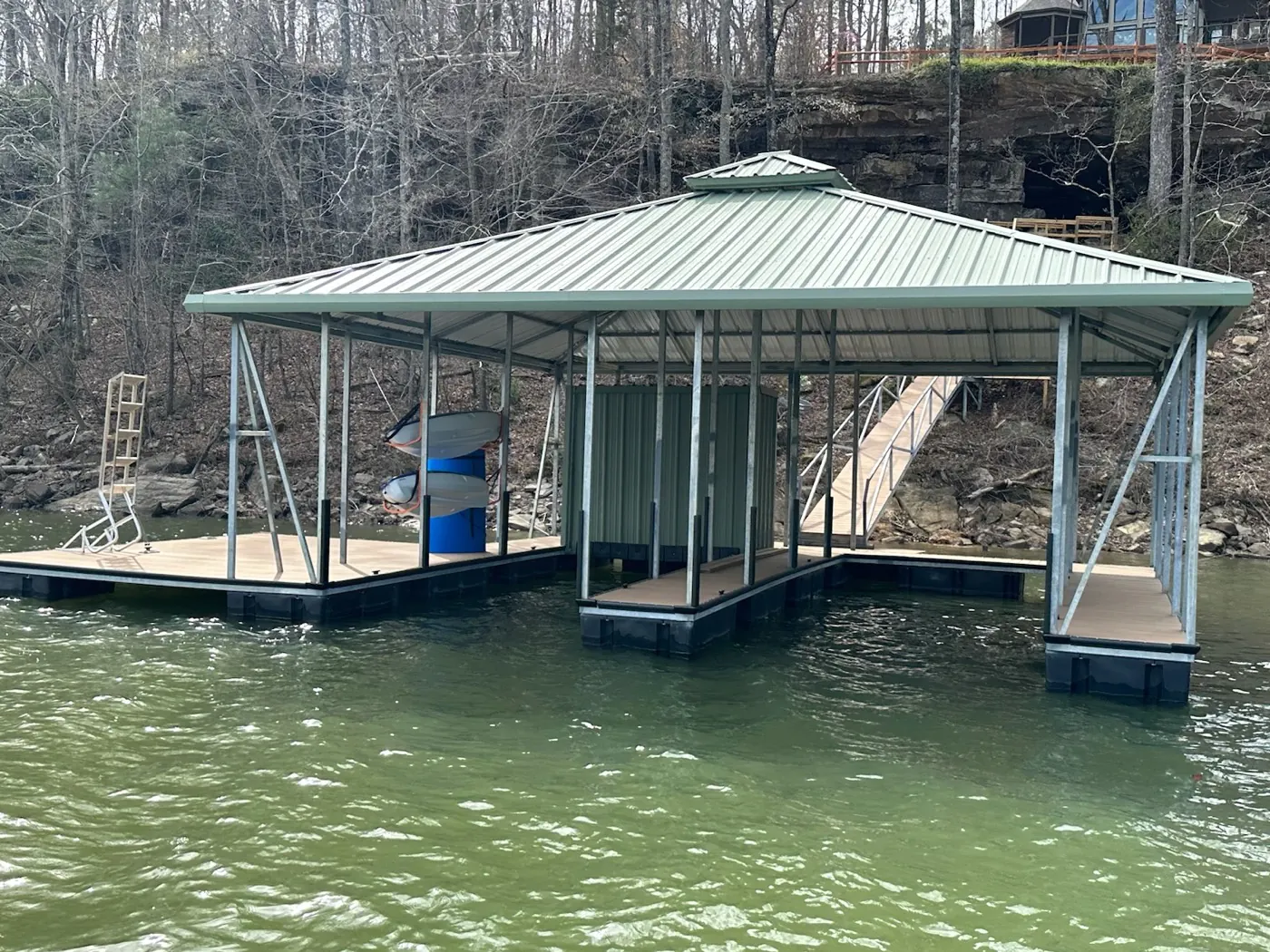 Well-maintained covered boat dock with sage metal roof and galvanized steel frame on Smith Lake